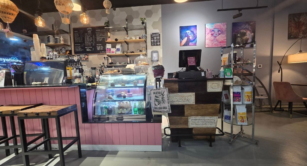 Grind Me Fine Coffee House interior with pink counter and pastry display